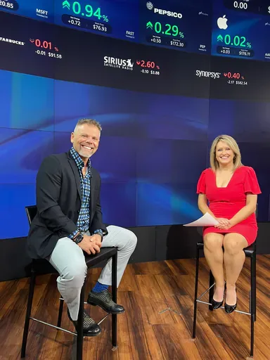 Charles Gaudet on a TV studio set with a show host