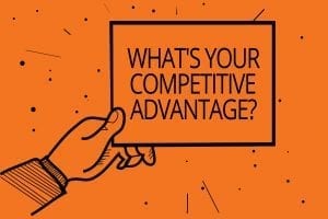 an illustration of a hand holding a sign that says "What's your competitive advantage?"