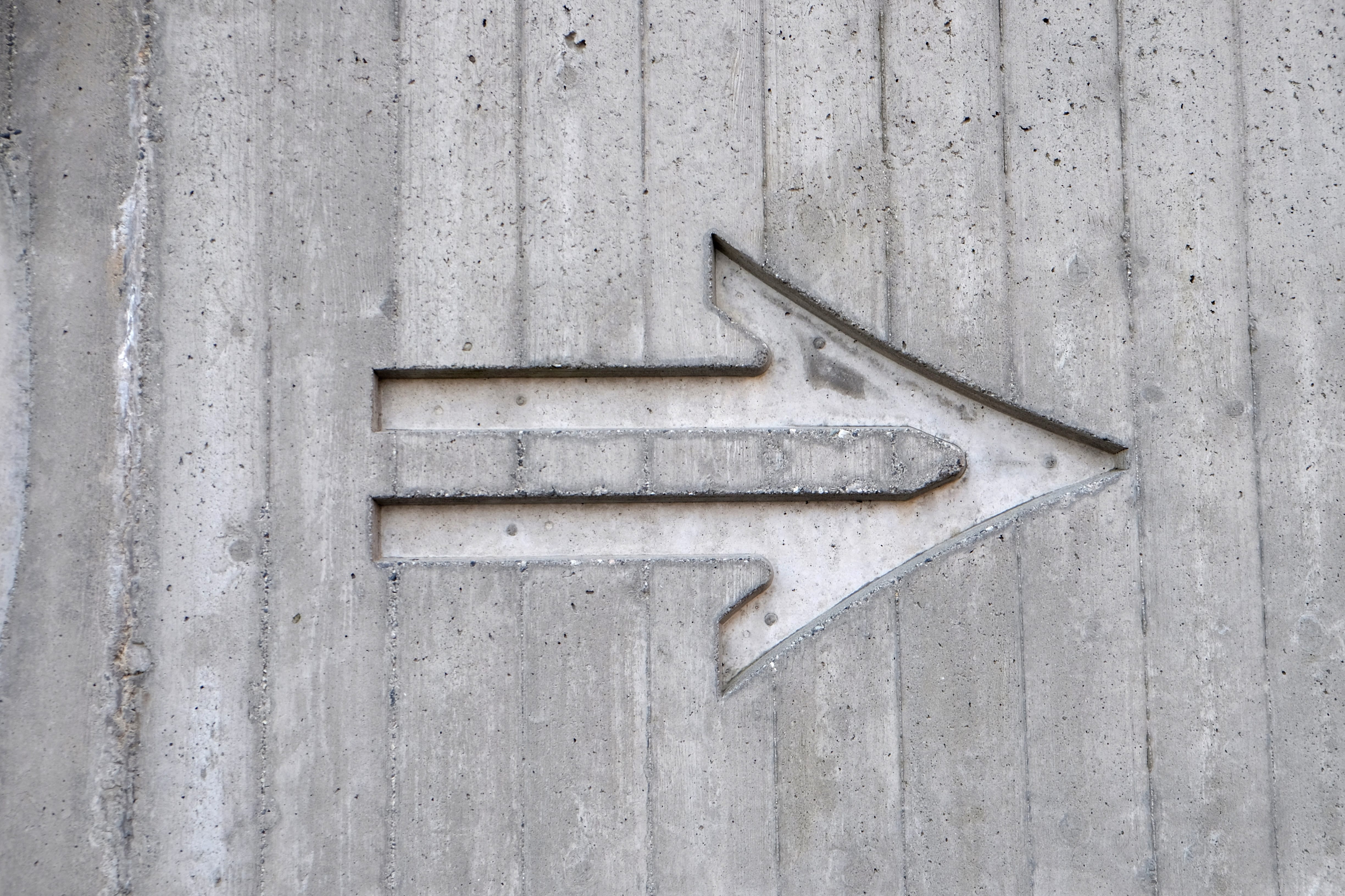 an direction arrow in cement pointing to the right