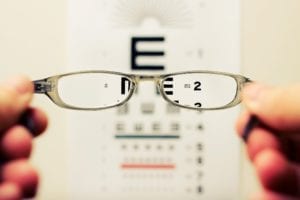 looking through glasses at a vision test chart