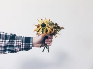 thumbnail image of hand outstretched holding flowers