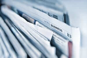 closeup of newspapers showing the business section