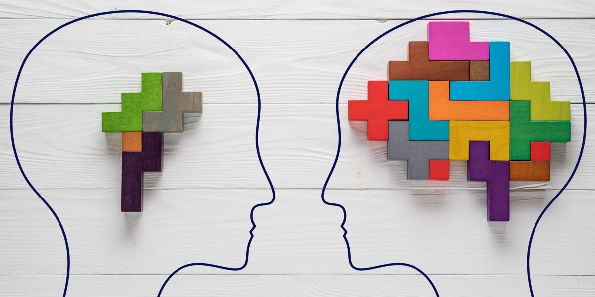 two outlines of heads on a white wooden background, with colorful block pieces representing how much each has in their mind.