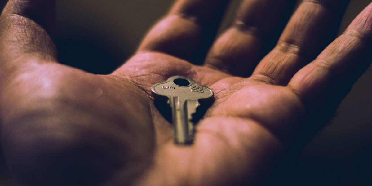 closeup of a hand holding a key