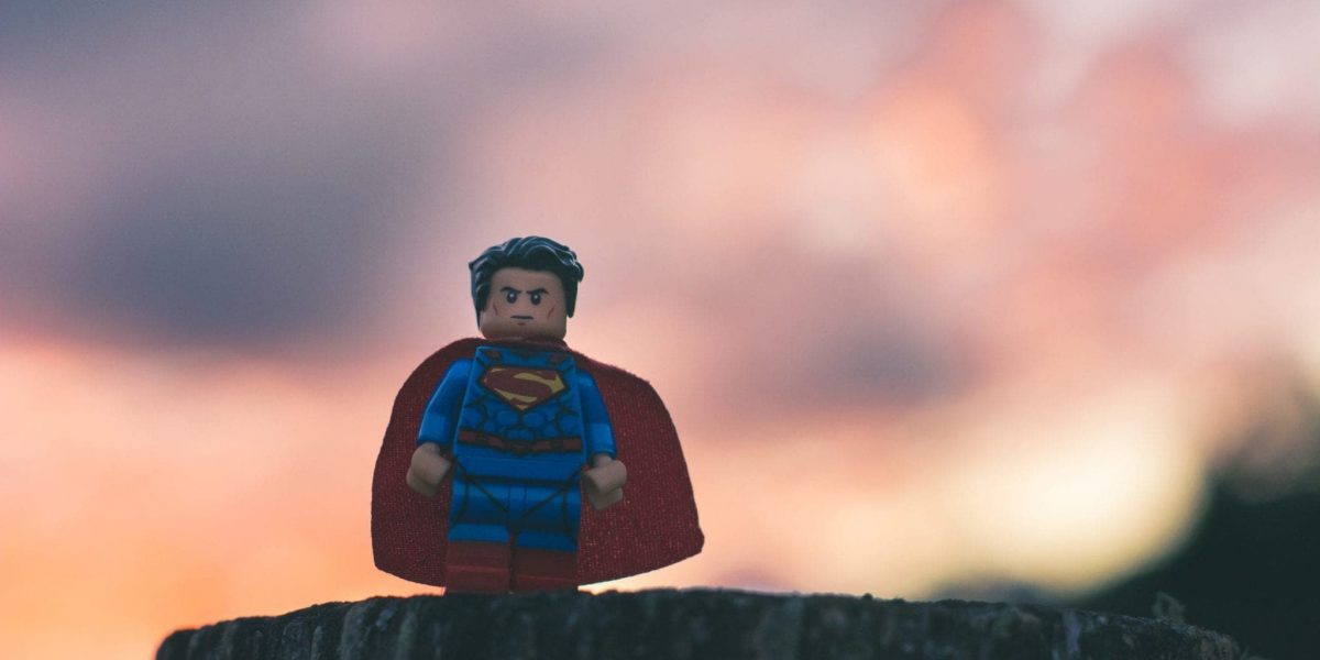 lego superman, a hero, with a sunset in the background