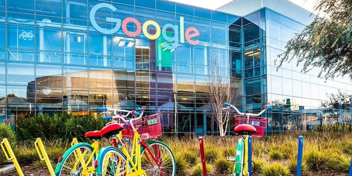 Google HQ (glass HQ building with bicycles parked on campus sidewalk)