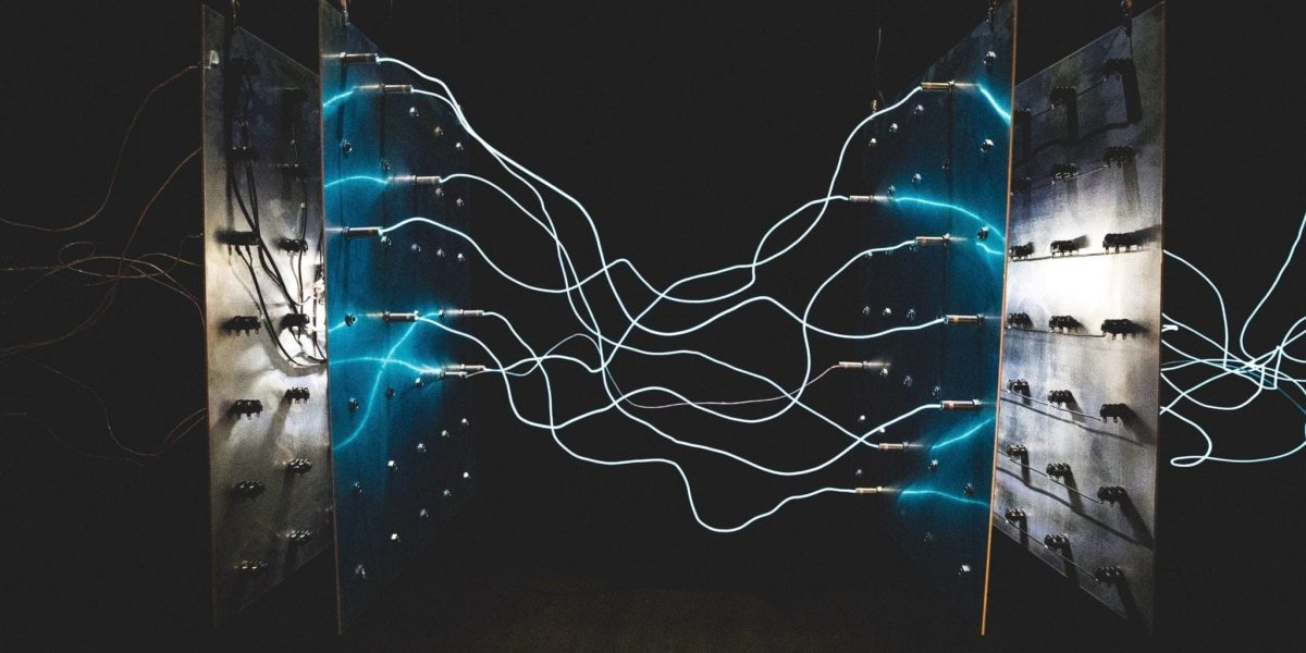 a photo of wires connected between two blue metal panels