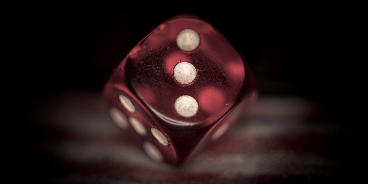 a single red die showing the number 3