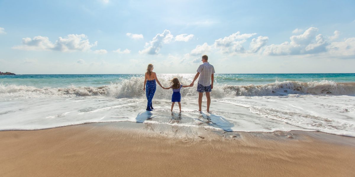a photo of a family on an ocean beach
