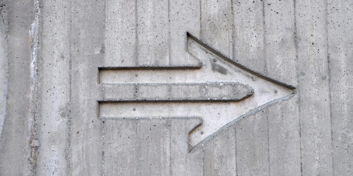 an direction arrow in cement pointing to the right